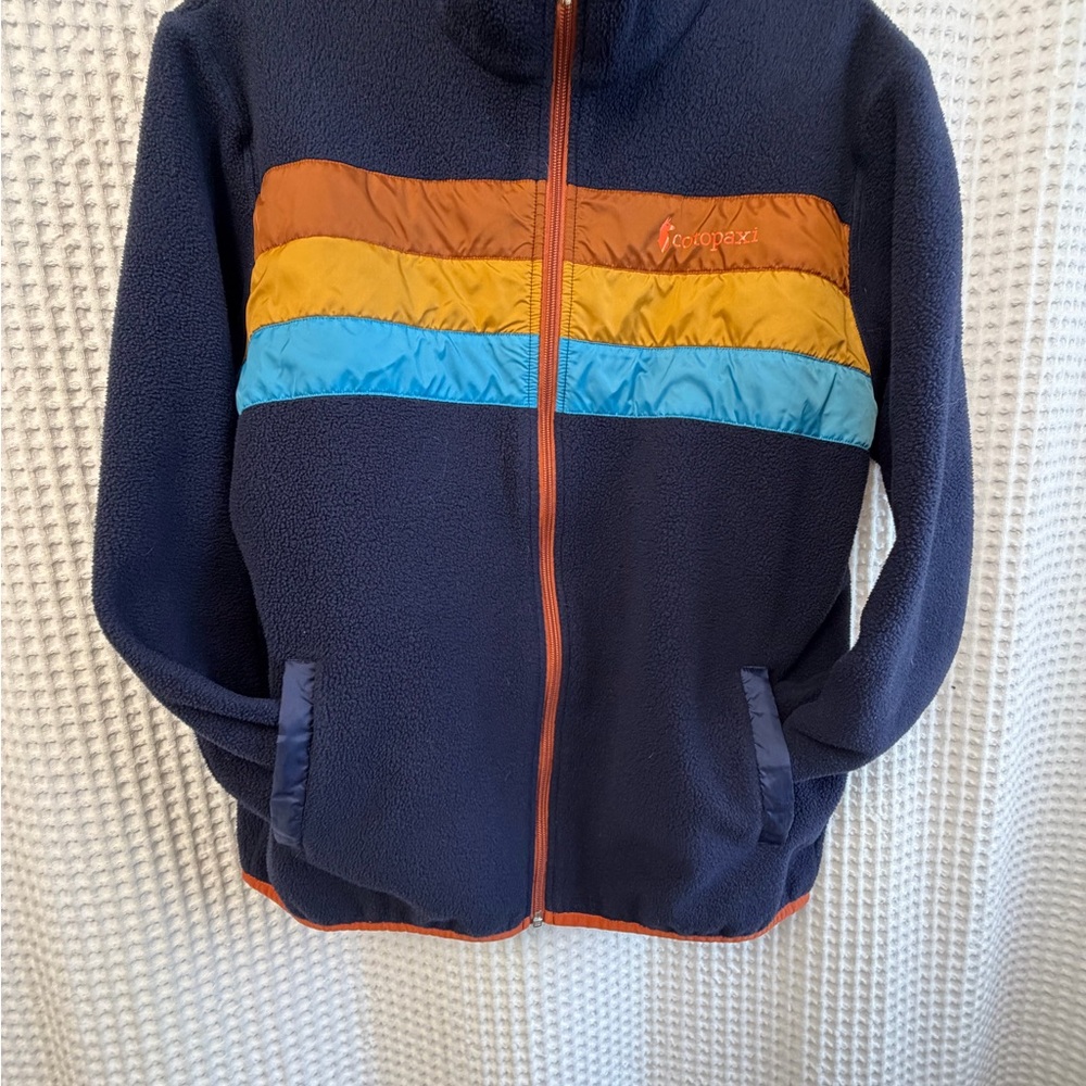 cotopaxi Navy Fleece Jacket with Orange, Yellow & Blue Chest Stripes